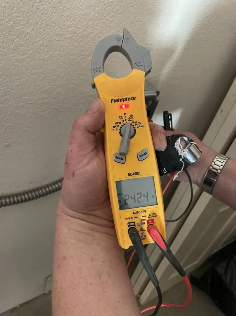 Voltage testing with clamp meter during Ceiling Fan Installation in Porter